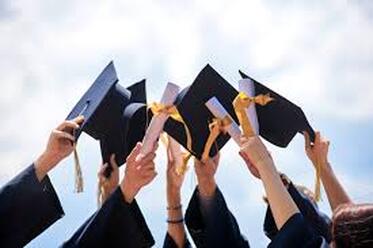 Hands holding up graduation caps and rolled up papers with yellow ribbon.